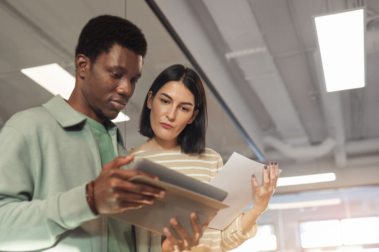 Two people reviewing a job description and policy wording during an any occupation disability review