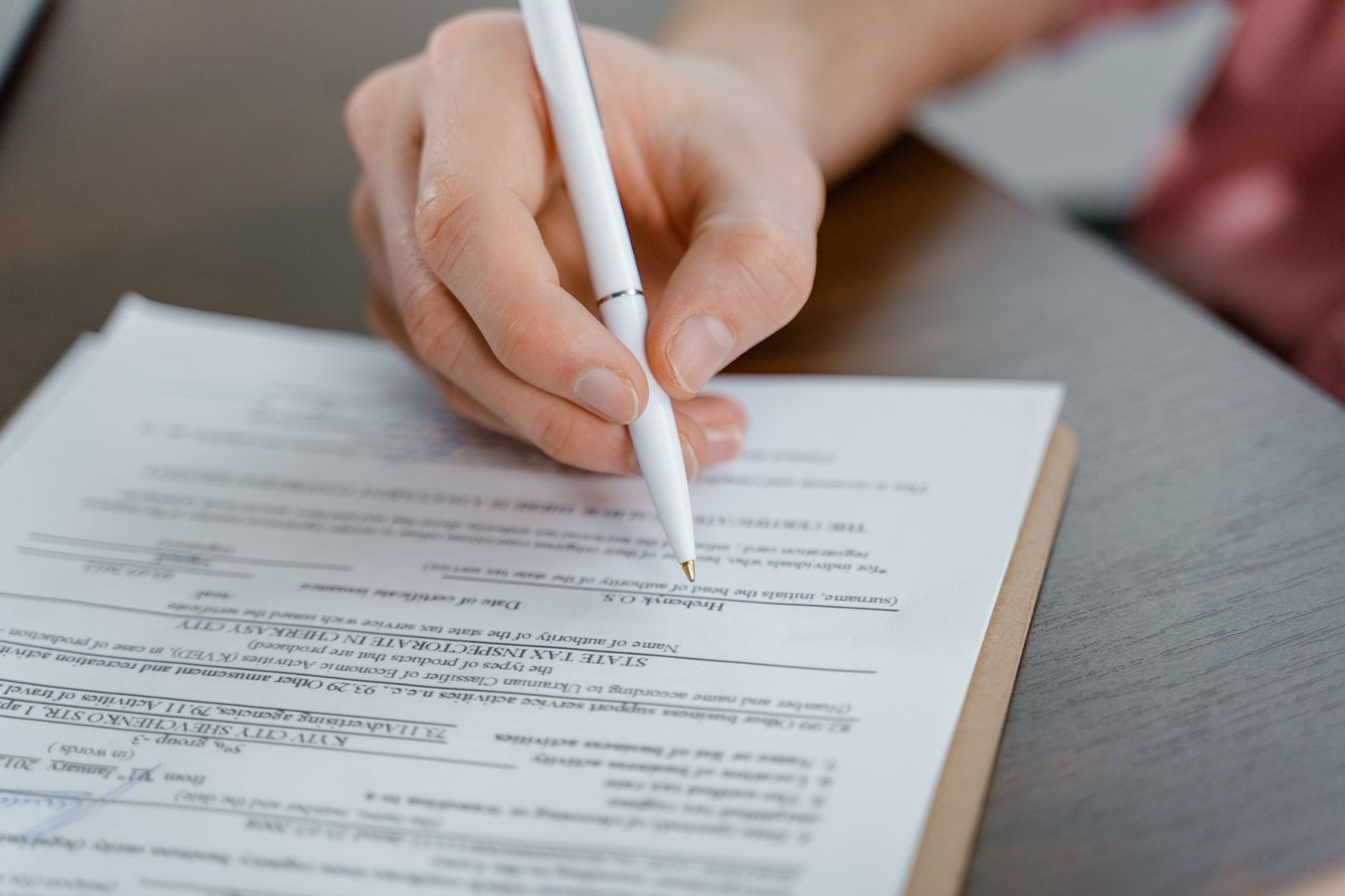 Person working through the SSDI application process with forms and a laptop at a desk