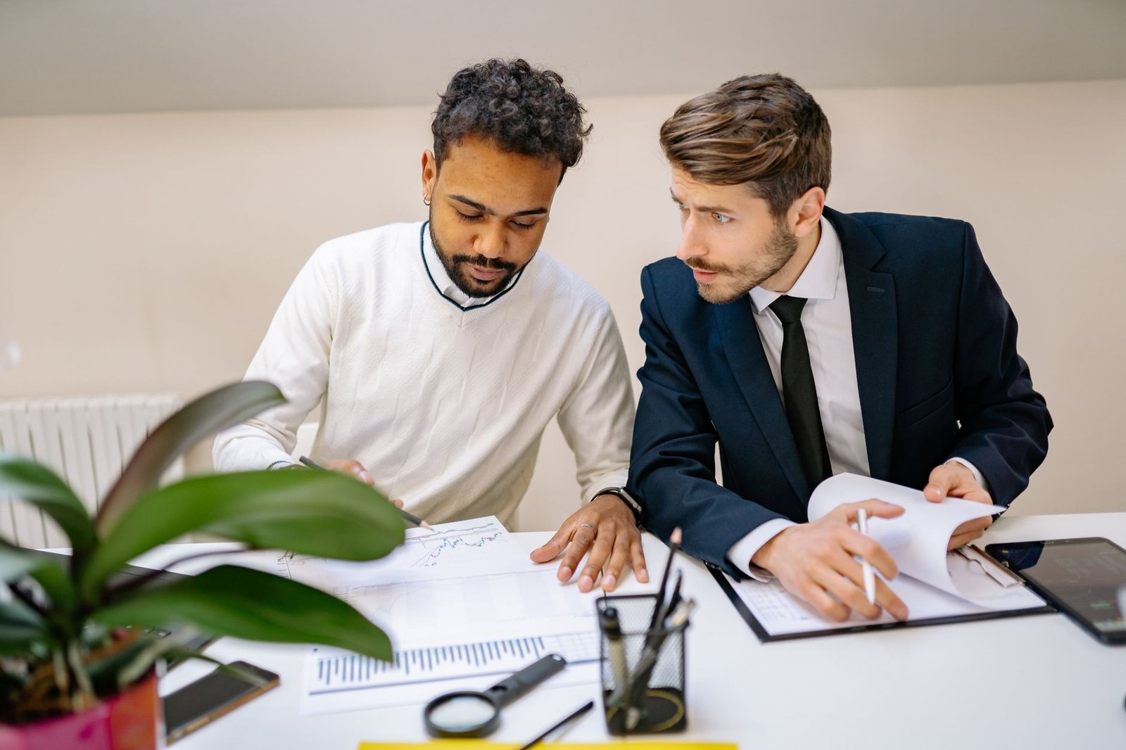 Two people organizing documents for a Social Security disability application at a table