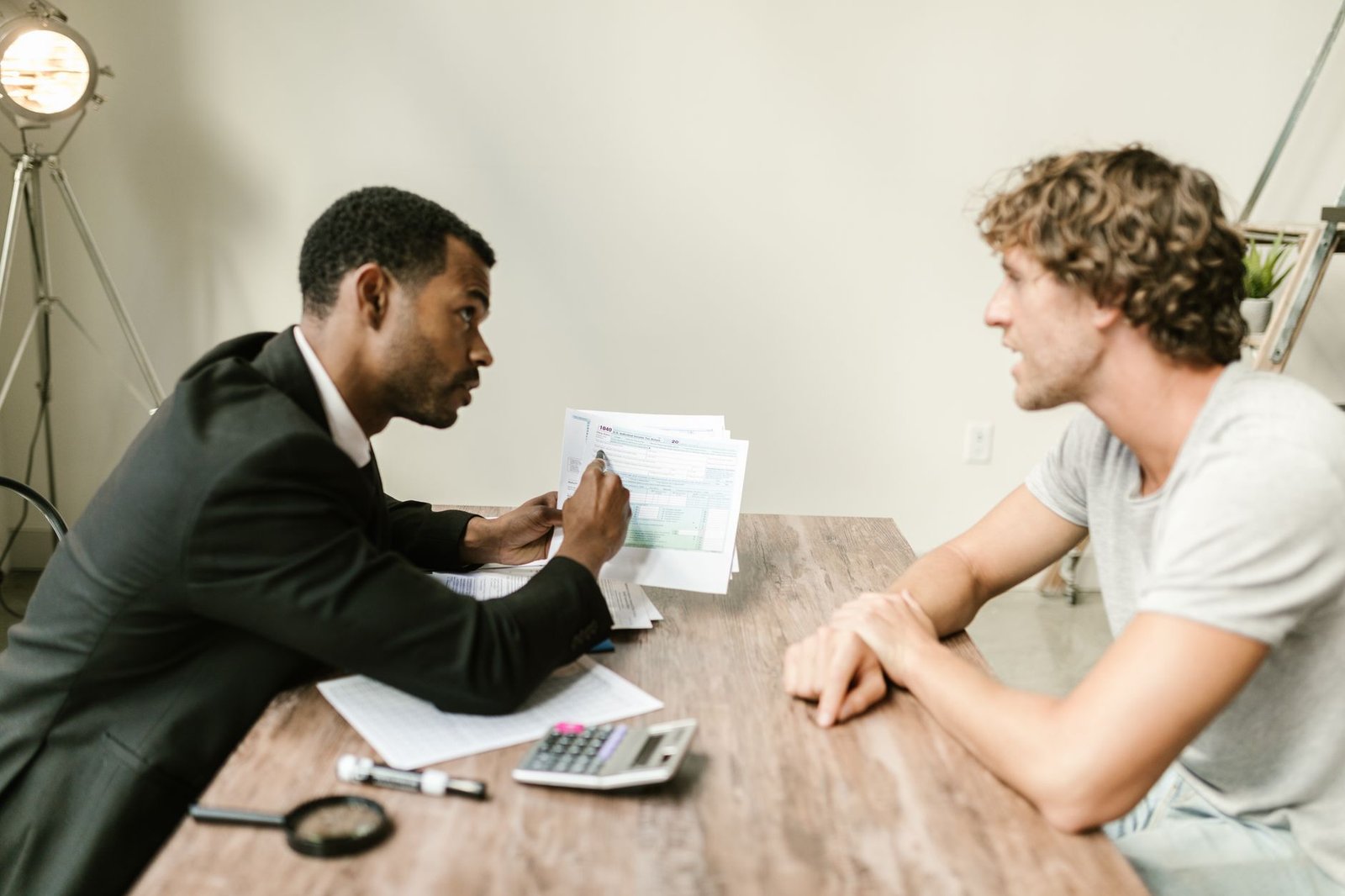 Two people reviewing a group long-term disability denial letter and appeal deadline paperwork