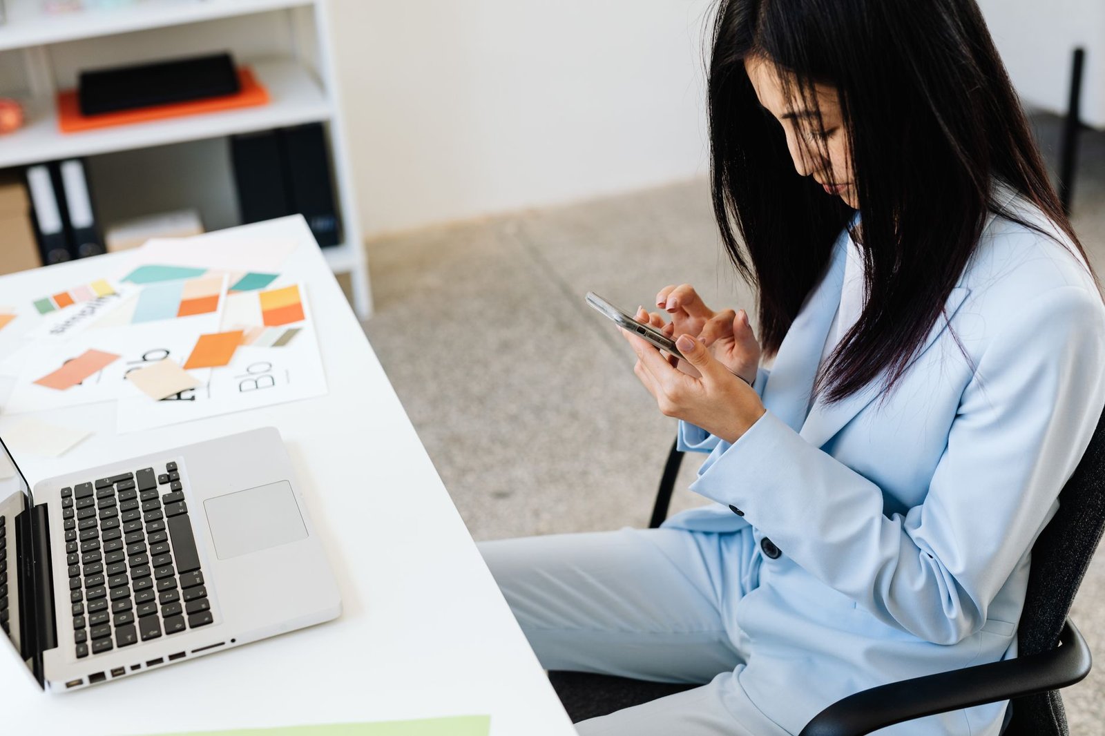 Person organizing long term disability for mental health claim paperwork at a desk